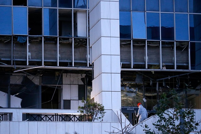 a police officer searches for evidence after a bomb blast at a court building in athens greece december 22 2017 photo reuters