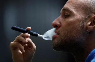 a man poses for a photograph while using a philip morris iqos smoking device photo reuters a man poses for a photograph while using a philip morris iqos smoking device photo reuters