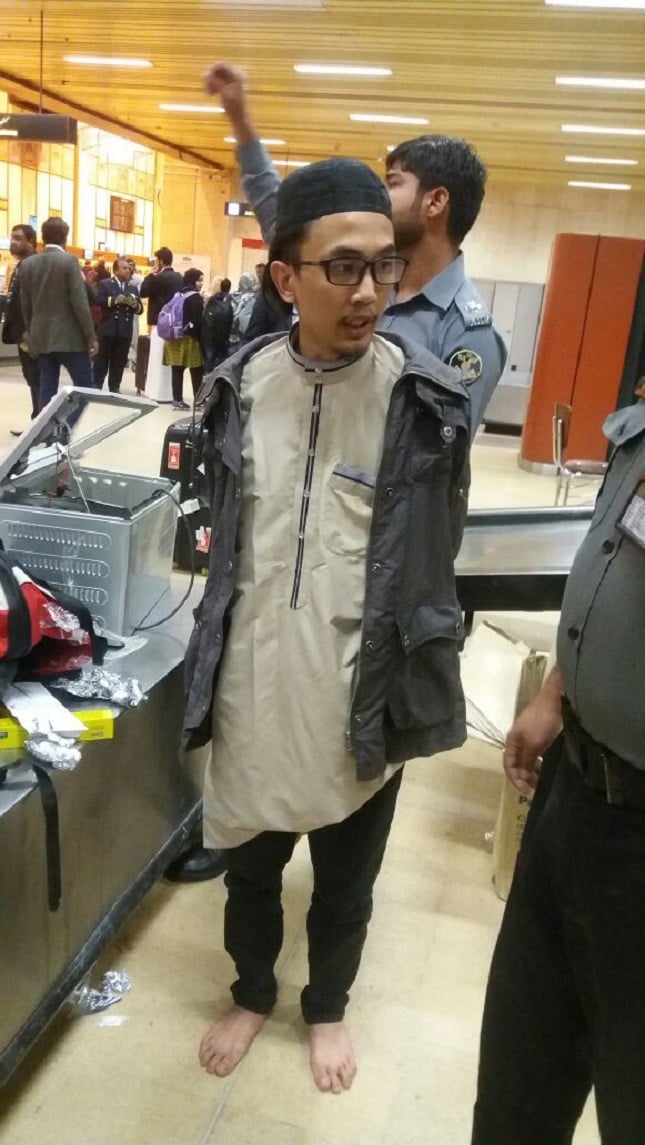 the security officials are trying to question him and ascertain as to why he would conceal pistols and ammunitions in his luggage photo express