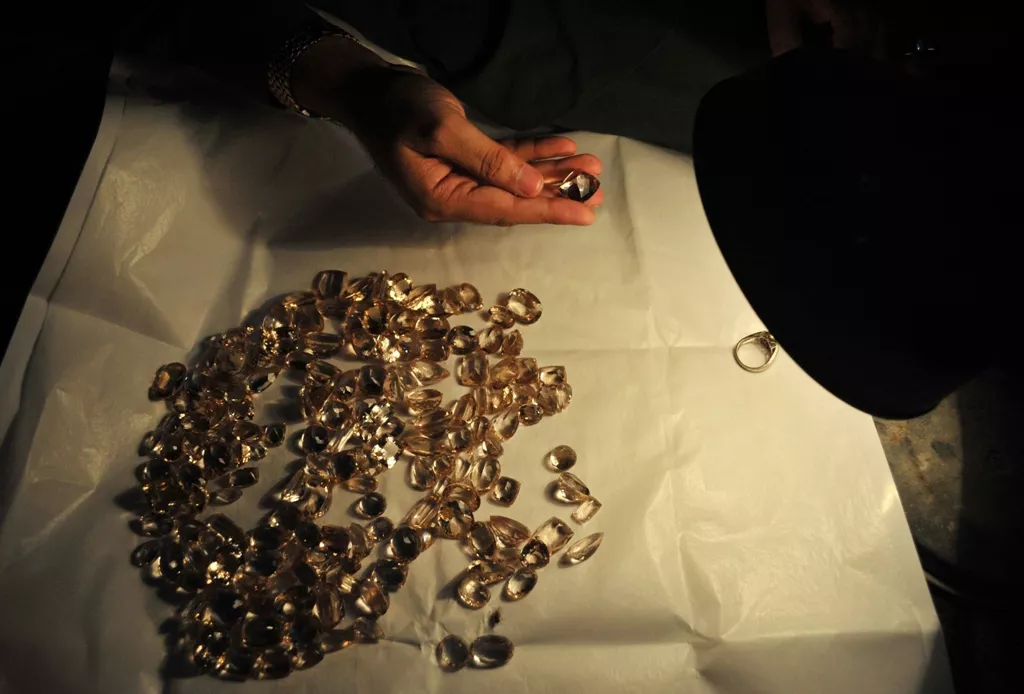 a craftsman checks a gemstone at a workshop in peshawar photo afp a craftsman checks a gemstone at a workshop in peshawar photo afp