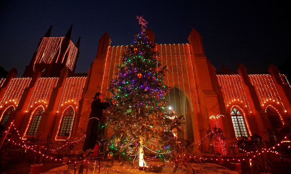 a man decorates a christmas tree at the st john cathedral church ahead of christmas celebrations in peshawar pakistan december 24 2016 reuters fayaz aziz