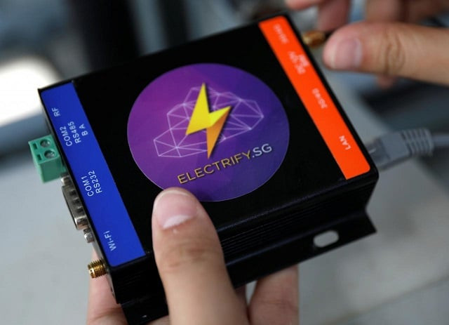 an electrify sg engineer shows a powerport that will be installed to record data of photovoltaic solar panels on a rooftop in singapore december 18 2017 photo reuters an electrify sg engineer shows a powerport that will be installed to record data of photovoltaic solar panels on a rooftop in singapore december 18 2017 photo reuters