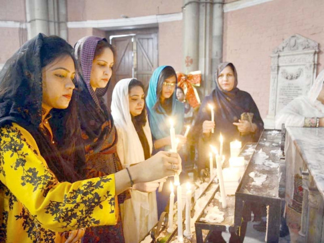 people light candles during christmas celebration photo online