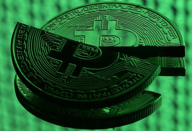 broken representations of the bitcoin virtual currency placed on a monitor that displays binary digits are seen in this illustration picture december 8 2017 photo reuters broken representations of the bitcoin virtual currency placed on a monitor that displays binary digits are seen in this illustration picture december 8 2017 photo reuters