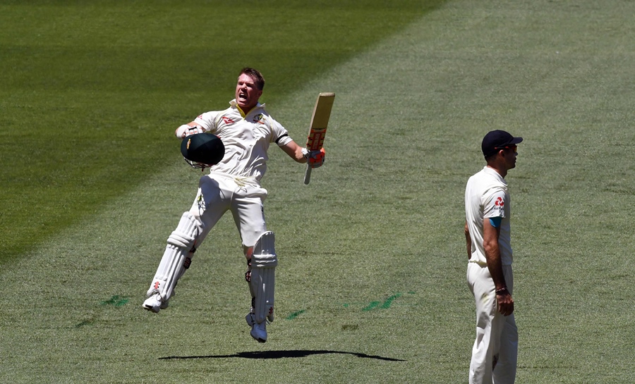 australia 039 s batsman david warner l leaps in the air as he celebrates scoring his century as england fieldsman james anderson r looks away on the first day of the fourth ashes cricket test match at the mcg in melbourne on december 26 2017 photo afp