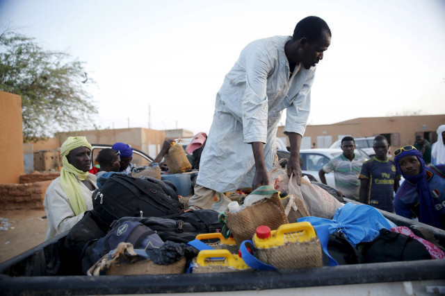 a man arranges the belongings of migrants into the back of a truck photo reuters a man arranges the belongings of migrants into the back of a truck photo reuters