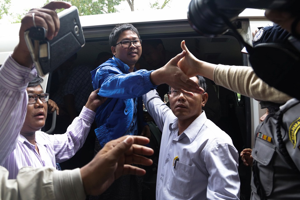 reuters reporter wa lone reaches out to hold the hand of his wife pan ei mon as he arrives at court in yangon myanmar december 27 2017 photo reuters