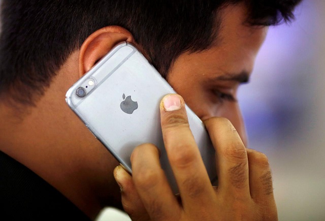 a man talks on his iphone at a mobile phone store in new delhi india july 27 2016 photo reuters