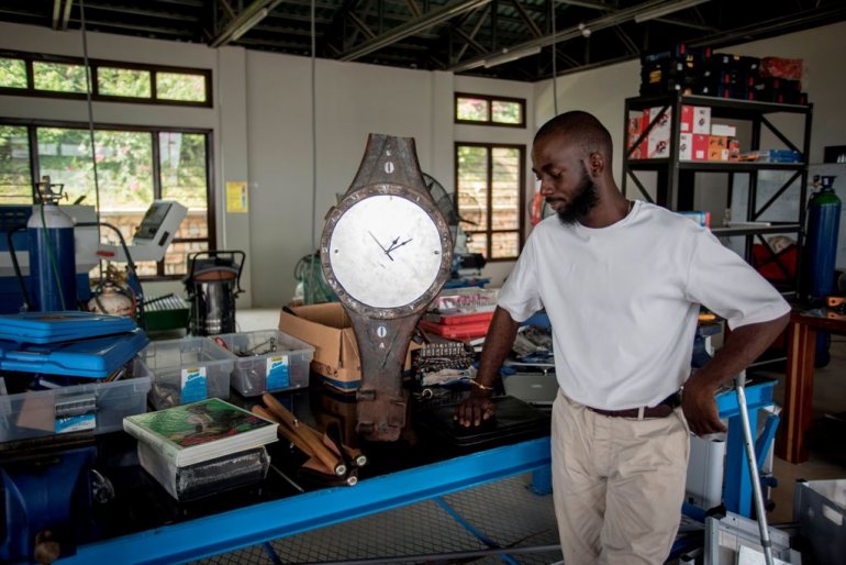 ghanaian artist joseph awuah darko working on a clock the pieces of which were found at agbogloshie dumpsite at his workshop at ashesi university college where he studies outside accra photo afp