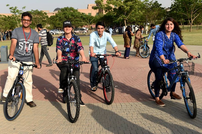 a group of students riding bikes at the soft launch of cykiq at nust campus islamabad photo reuters