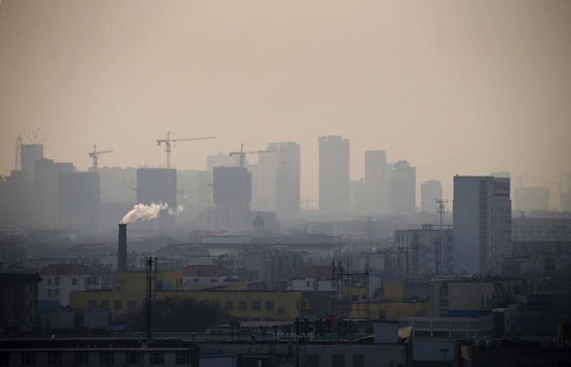 file photo smoke rises from a chimney among houses as new high rise residential buildings are seen under construction on a hazy day in the city centre of tangshan hebei province in this february 18 2014 file photo photo reuters