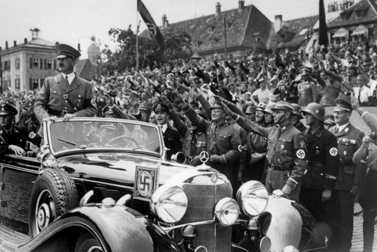 german chancellor adolf hitler standing in a convertible mercedes reviews sa and ss troops and wellwishers in 1937 somewhere in germany photo afp