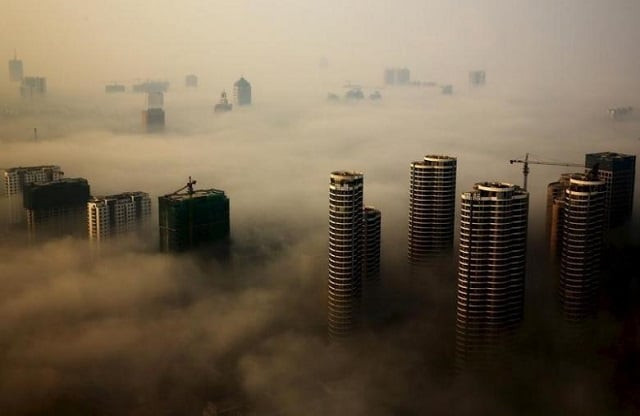 file photo buildings in construction are seen among mist during a hazy day in rizhao shandong province china october 18 2015 photo reuters