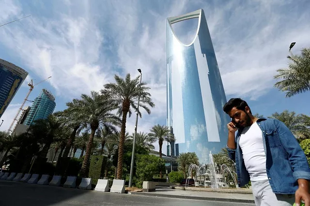 a man speaks on the phone as he walks past the kingdom centre tower in riyadh saudi arabia november 5 2017 photo reuters a man speaks on the phone as he walks past the kingdom centre tower in riyadh saudi arabia november 5 2017 photo reuters
