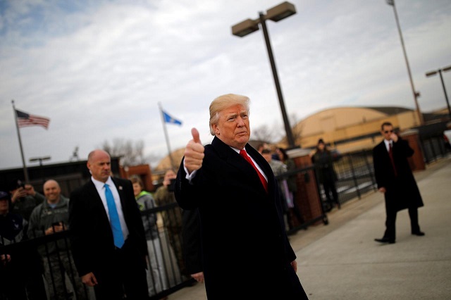 us president donald trump gives a thumbs up to reporters as he boards air force one for travel to palm beach from joint base andrews maryland us december 22 2017 photo reuters