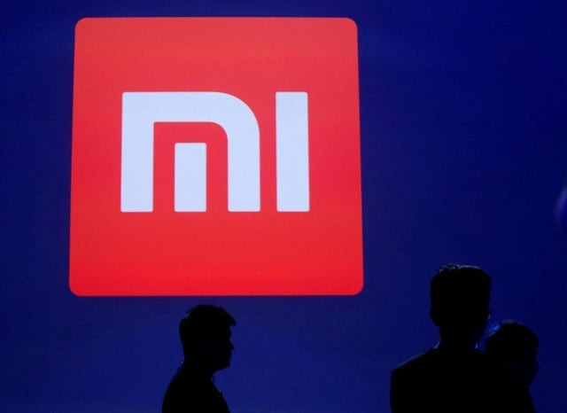 attendants are silhouetted in front of xiaomi s logo at a venue for the launch ceremony of xiaomi s new smart phone mi max in beijing may 10 2016 photo reuters attendants are silhouetted in front of xiaomi s logo at a venue for the launch ceremony of xiaomi s new smart phone mi max in beijing may 10 2016 photo reuters