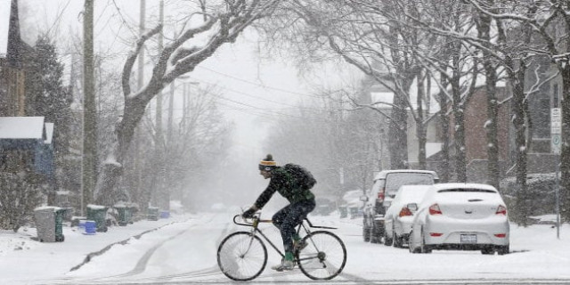 a man rides a bicycle during a snow storm in ottawa canada photo reuters a man rides a bicycle during a snow storm in ottawa canada photo reuters