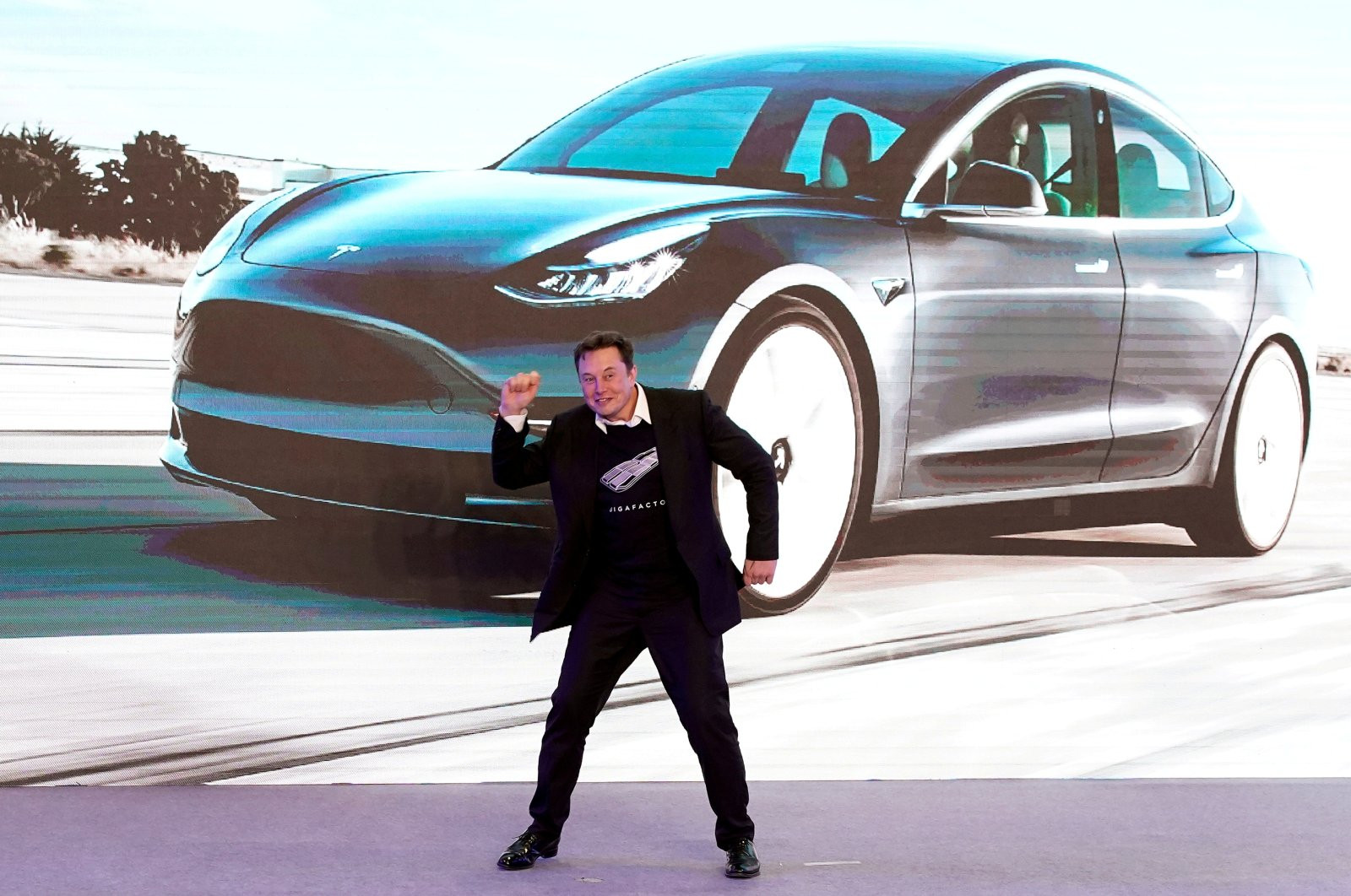 dancing elon musk hands drivers first teslas from germany s new gigafactory