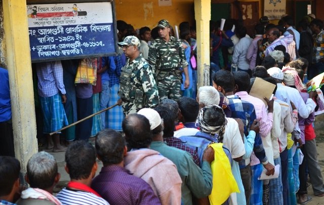 people stand in line to check their names on the first draft of the national register of citizens nrc at gumi village of kamrup district in the indian state of assam on monday photo afp