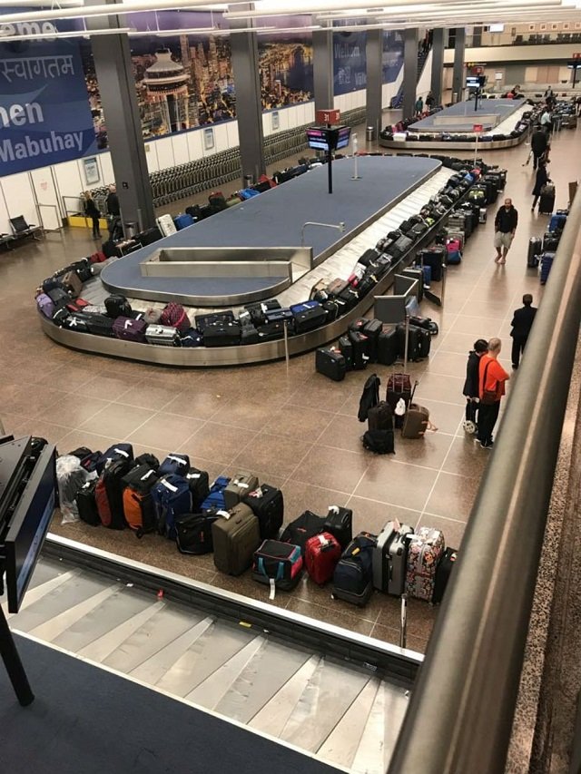 luggages pile up at a carousel at a baggage claims area during a systems outage at sea tac airport in seattle washington us in this january 1 2018 picture obtained from social media photo via reuters