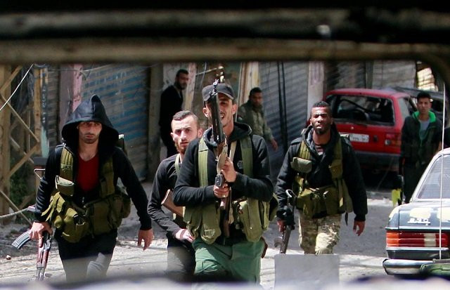 file photo members of the palestinian fatah faction walk with their weapons as seen through a damaged car inside the ain el hilweh refugee camp near sidon southern lebanon april 11 2017 photo reuters file photo members of the palestinian fatah faction walk with their weapons as seen through a damaged car inside the ain el hilweh refugee camp near sidon southern lebanon april 11 2017 photo reuters