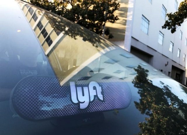 an illuminated sign appears in a lyft ride hailing car in los angeles california us september 21 2017 photo reuters