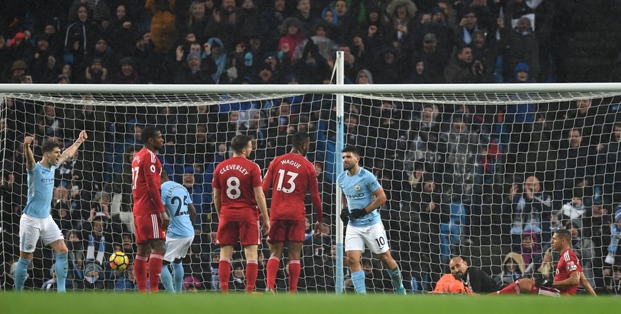 manchester city 039 s argentinian striker sergio aguero scores their third goal past watford 039 s brazilian goalkeeper heurelho gomes 2r during the english premier league football match between manchester city and watford at the etihad stadium in manchester north west england on january 2 2018 photo afp