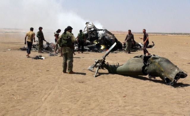 the mi 24 military helicopter had tripped over power line wires and crashed while escorting a convoy photo afp the mi 24 military helicopter had tripped over power line wires and crashed while escorting a convoy photo afp