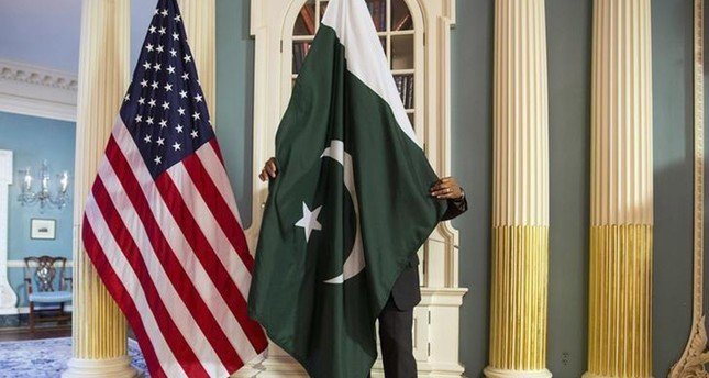 a state department contractor adjust a pakistan national flag before a meeting at the state department in washington photo reuters
