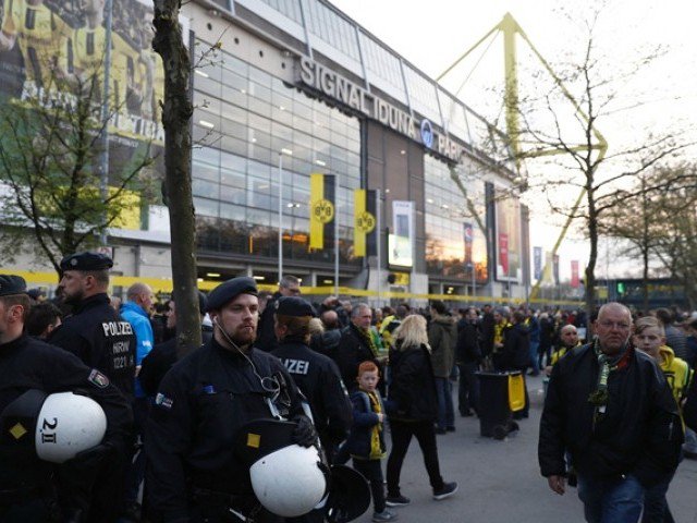 police patrol outide the stadium after the team bus of borussia dortmund had some windows broken by an explosion some 10km away from the stadium prior to the uefa champions league 1st leg quarter final football match bvb borussia dortmund v monaco in dortmund western germany on april 11 2017 photo afp