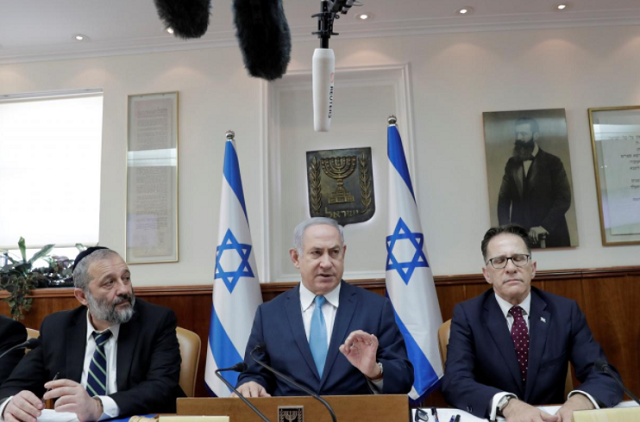 israeli prime minister benjamin netanyahu sits next to israeli interior minister aryeh deri and israeli cabinet secretary tzachi braverman during a cabinet meeting at the prime minister 039 s office in jerusalem photo reuters