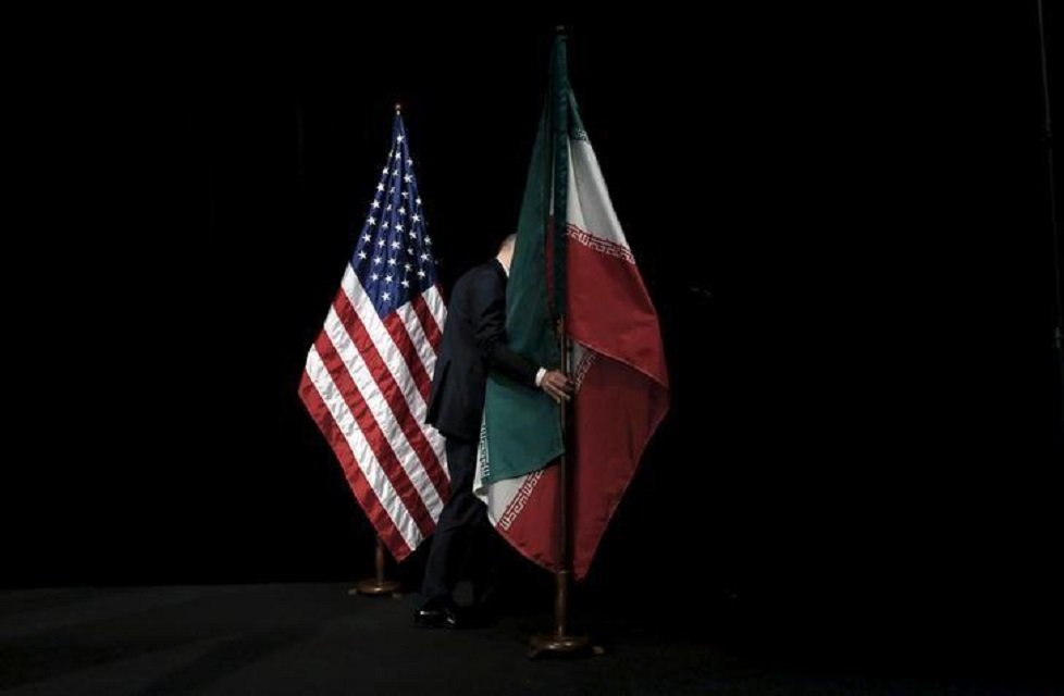 a staff member removes the iranian flag from the stage after a group picture with foreign ministers and representatives of the us iran china russia britain germany france and the european union during the iran nuclear talks at the vienna international center in vienna austria july 14 2015 photo reuters