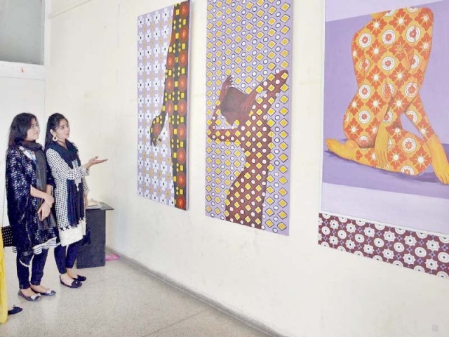 traditional arts and fine arts students taking keen interest in art work during an exhibition at uaf photo inp traditional arts and fine arts students taking keen interest in art work during an exhibition at uaf photo inp
