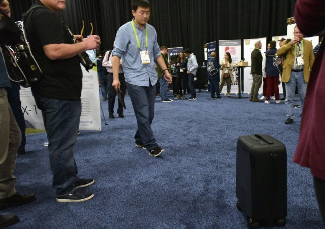 an exhibitor demonstrates the forwardx robotics self driving cx 1 suitcase during the ces unveiled event on the sidelines of ces 2018 in las vegas photo afp an exhibitor demonstrates the forwardx robotics self driving cx 1 suitcase during the ces unveiled event on the sidelines of ces 2018 in las vegas photo afp