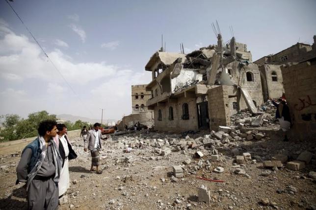 people look at the rubble of a house destroyed by a saudi led airstrike in yemen 039 s capital sanaa photo reuters