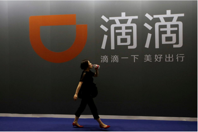 a woman walks past ride hailing company didi chuxing 039 s booth at the global mobile internet conference gmic 2017 in beijing china april 28 2017 photo reuters