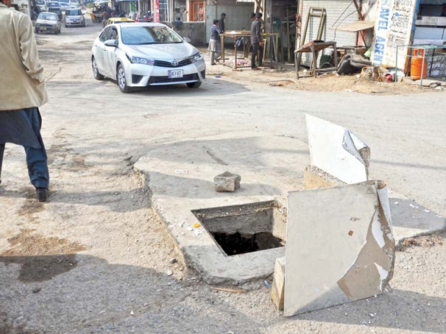 an open manhole at a commercial area in the capital photo zafar aslam express an open manhole at a commercial area in the capital photo zafar aslam express