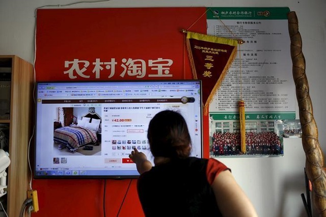 a customer points at a screen displaying a website of alibaba 039 s taobao at a rural service centre in yuzhao village tonglu zhejiang province china july 20 2015 photo reuters