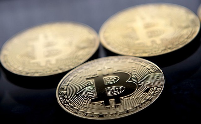 this file photo taken on november 20 2017 shows gold plated souvenir bitcoin coins arranged for a photograph in london photo afp