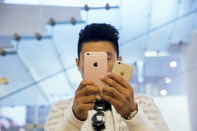 a man takes pictures as apple iphone 6s and 6s plus go on sale at an apple store in beijing china september 25 2015 photo reuters