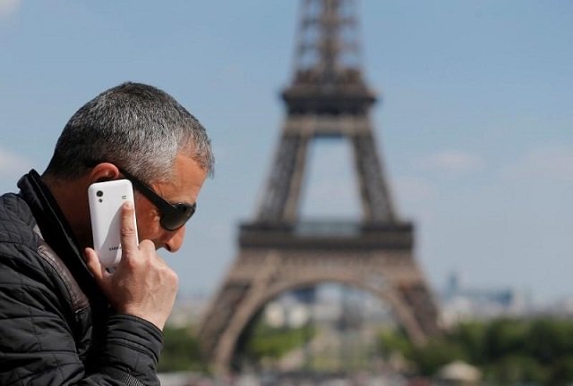 a man makes a phone call using his mobile phone at the trocadero square near the eiffel tower in paris may 16 2014 photo reuters
