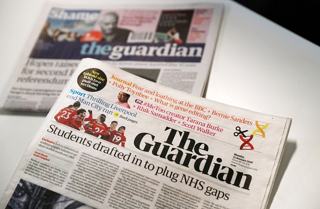the new look tabloid guardian is on show next to the old broadsheet version of the national newspaper on january 15 2018 photo afp