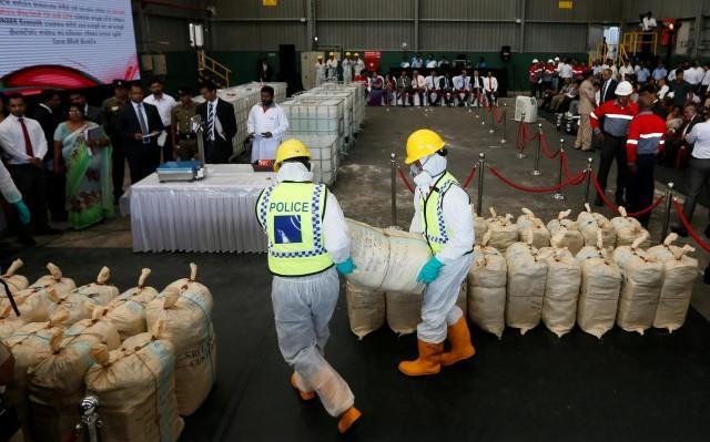 police officers carry a haul of seized cocaine sack to be destroyed under judicial supervision in katunayake sri lanka january 15 2018 photo reuters