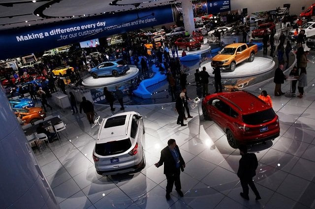 visitors look at cars in the ford booth at the north american international auto show in detroit michigan us january 15 2018 photo reuters visitors look at cars in the ford booth at the north american international auto show in detroit michigan us january 15 2018 photo reuters