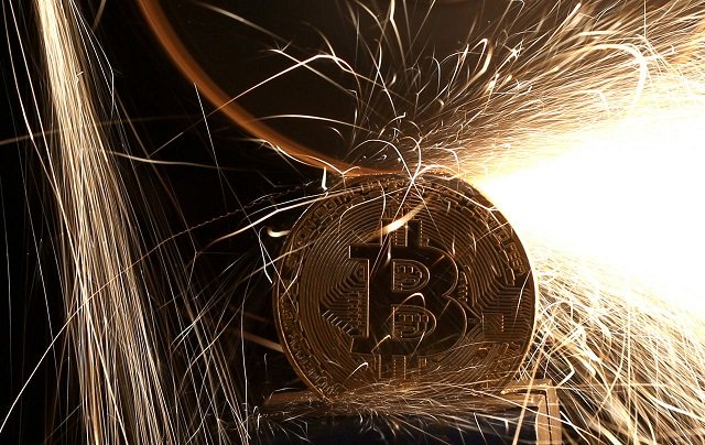 sparks glow from broken bitcoin virtual currency coins in this illustration picture december 8 2017 photo reuters
