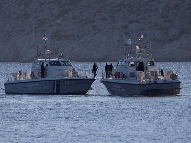 coastguard boats inspect the area where four people including a nine year old girl died and at least five were injured after a boat with about 20 people on board collided with a speedboat off the greek holiday island of aegina close to athens photo reuters file