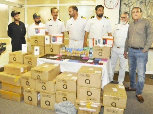 customs officials with the seized phones photo express file
