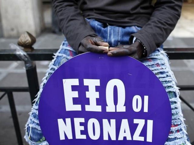 a migrant holds a sign decrying neo nazis in the greek capital photo reuters file