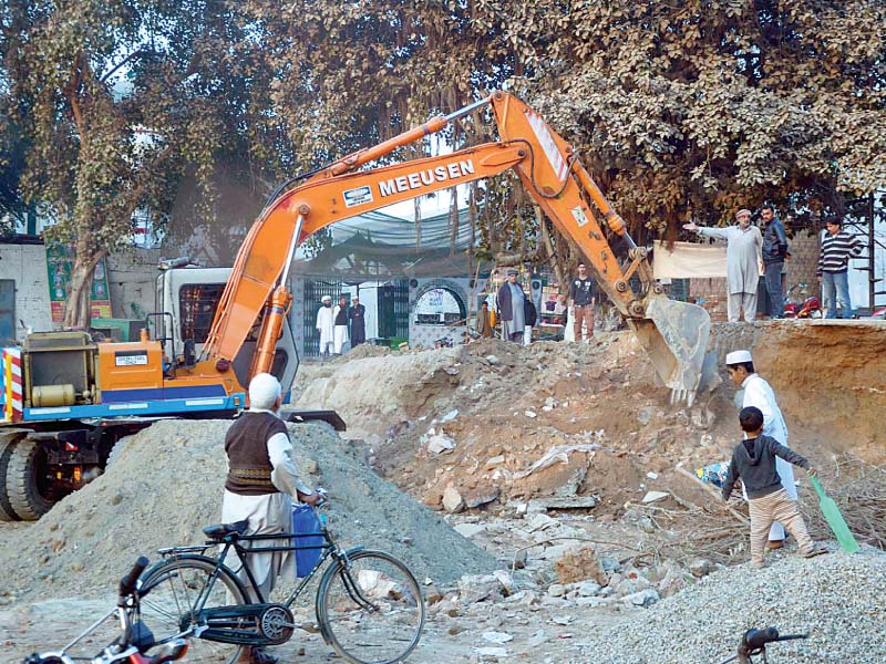 work of orange line metro train project in progress near over 450 year old shrine of baba mauj darya photo online