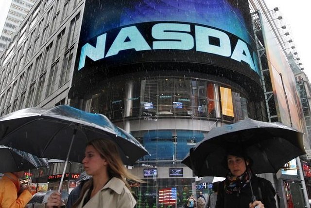 commuters pass by the nasdaq marketsite in new york may 21 2012 photo reuters